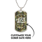Close-up of camo Sobriety Gift dog tag engraved with One Day at a Time